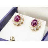 A pair of continental yellow metal ruby and diamond earrings, the cabochon rubies in four claw