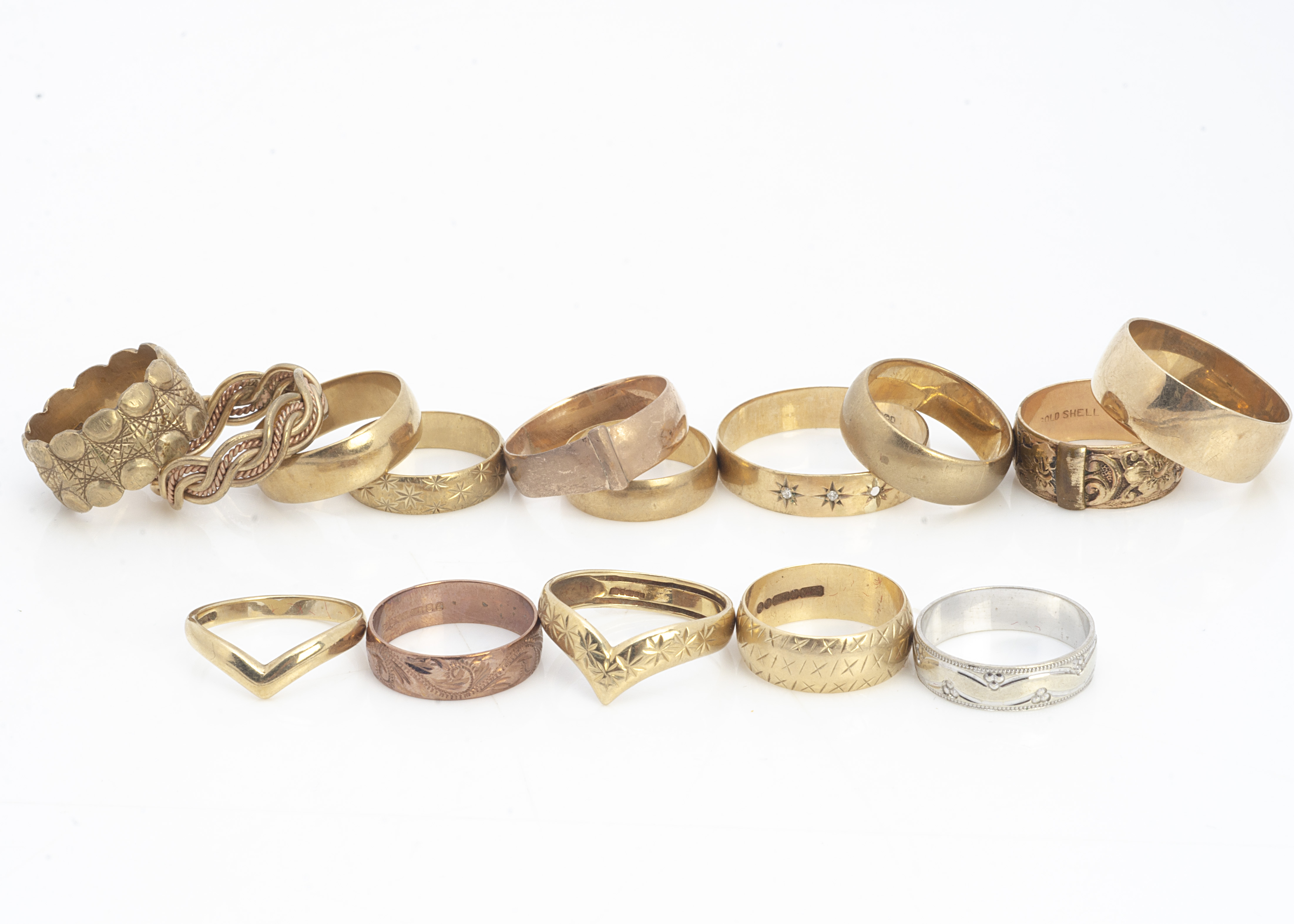 Fifteen 9ct gold wedding bands, of various designs including buckles, shaped, rope twist, wishbone