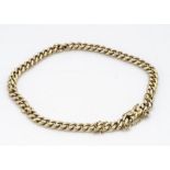 A yellow metal curb link bracelet, with box and tongue clasp, oval linked safety chain, unmarked,