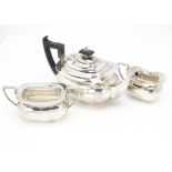 A George V silver three piece tea set by Walker & Hall, teapot with applied black handle and finial,