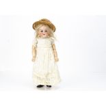 A German bisque headed child doll marked C, with blue sleeping eyes, replaced blonde mohair wig,