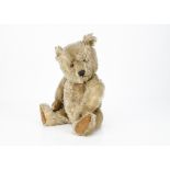 A Chiltern Hugmee teddy bear late 1950s, with blonde mohair, orange and black plastic eyes, black