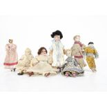 Seven dolls' house dolls, two white bisque headed dressed as the lady of the house and house