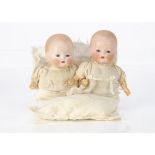 Two Armand Marseille babies for Louis Amberg &Son, with blue sleeping eyes, blonde painted hair,