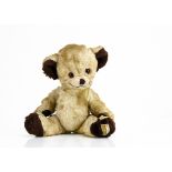 A rare Merrythought Cheeky teddy bear late 1950s, with pale yellow artificial silk plush, orange and