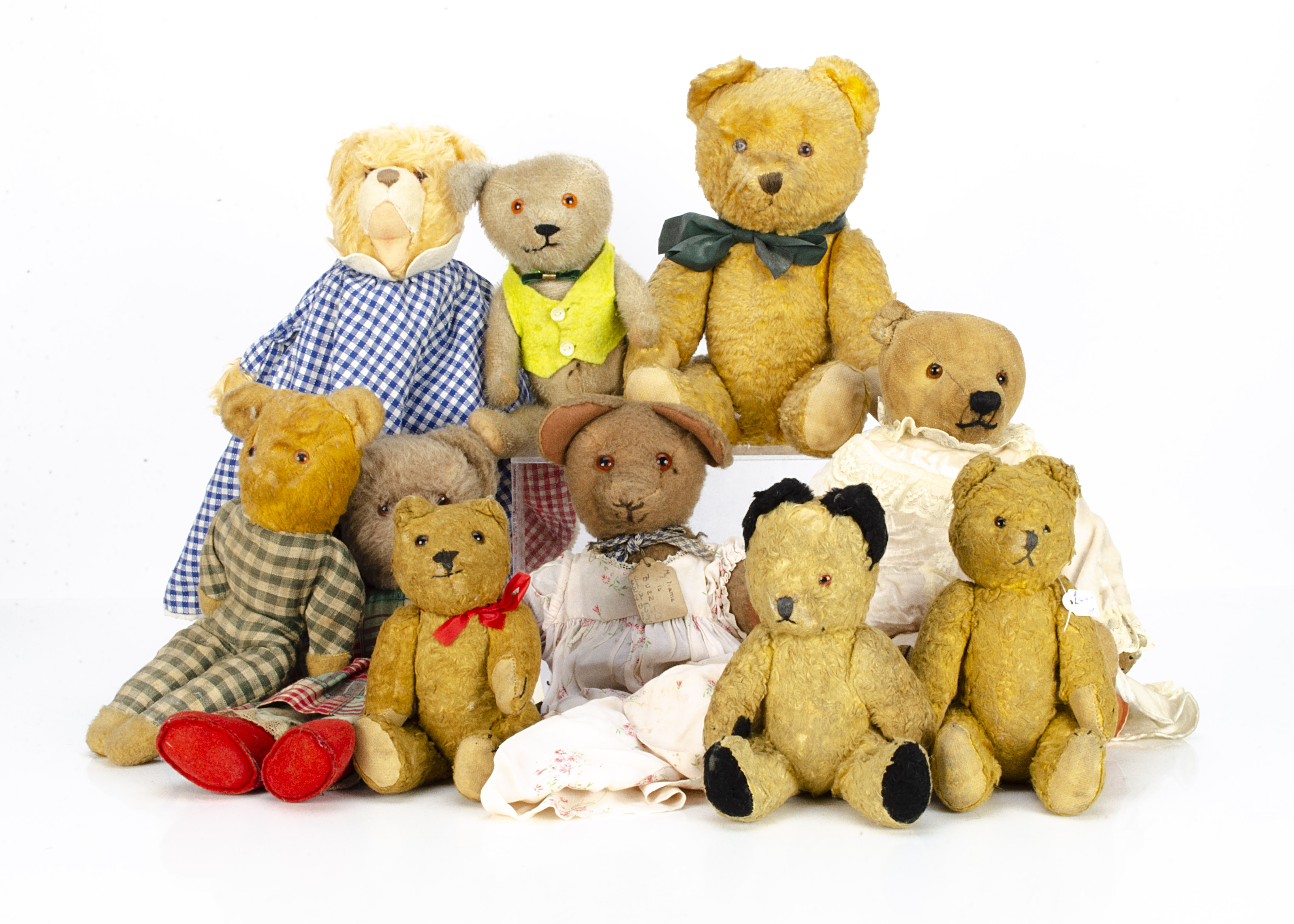 Various teddy bears, a worn jointed 1930s teddy bear in dress --15in. (38cm.) high; a pin-jointed
