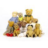 Various teddy bears, a worn jointed 1930s teddy bear in dress --15in. (38cm.) high; a pin-jointed