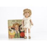 An Ideal composition Shirley Temple doll, with sleeping eyes, blonde mohair wig, jointed body and