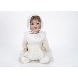 A Kämmer & Reinhardt 126 character baby, with blue lashed flirty sleeping eyes, brown mohair wig,