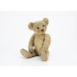 An early American teddy bear circa 1908, with blonde mohair, black boot button eyes, pronounced