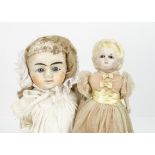A German dipped wax over composition Pumpkin head doll, with dark glass eyes, moulded blonde hair,