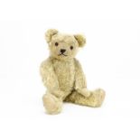 'Muzzle' a British teddy bear 1930s, with pale golden mohair, orange and black glass eyes,