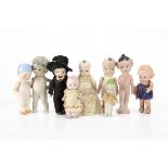 Nine comic child dolls, three Thumbs Ups, one dress as a groom; a Hewitt British bisque Dinky figure