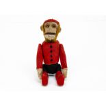 A Schuco yes/no Bellhop monkey 1920s, with flocked tinplate face and painted eyes, tail operated