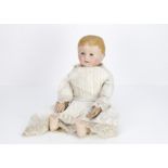 A Martha Chase cloth doll, with painted blue eyes, painted and textured blonde hair, sculpted