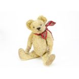 An early British teddy bear circa 1920s, with blonde mohair, clear and black glass eyes with remains