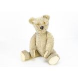 A Chad Valley moon-eyed teddy bear 1920s, with blonde mohair, clear and black glass eyes with yellow