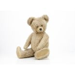 A 1950s Diem teddy bear, with beige mohair, clear and black glass eyes with beige painted backs,