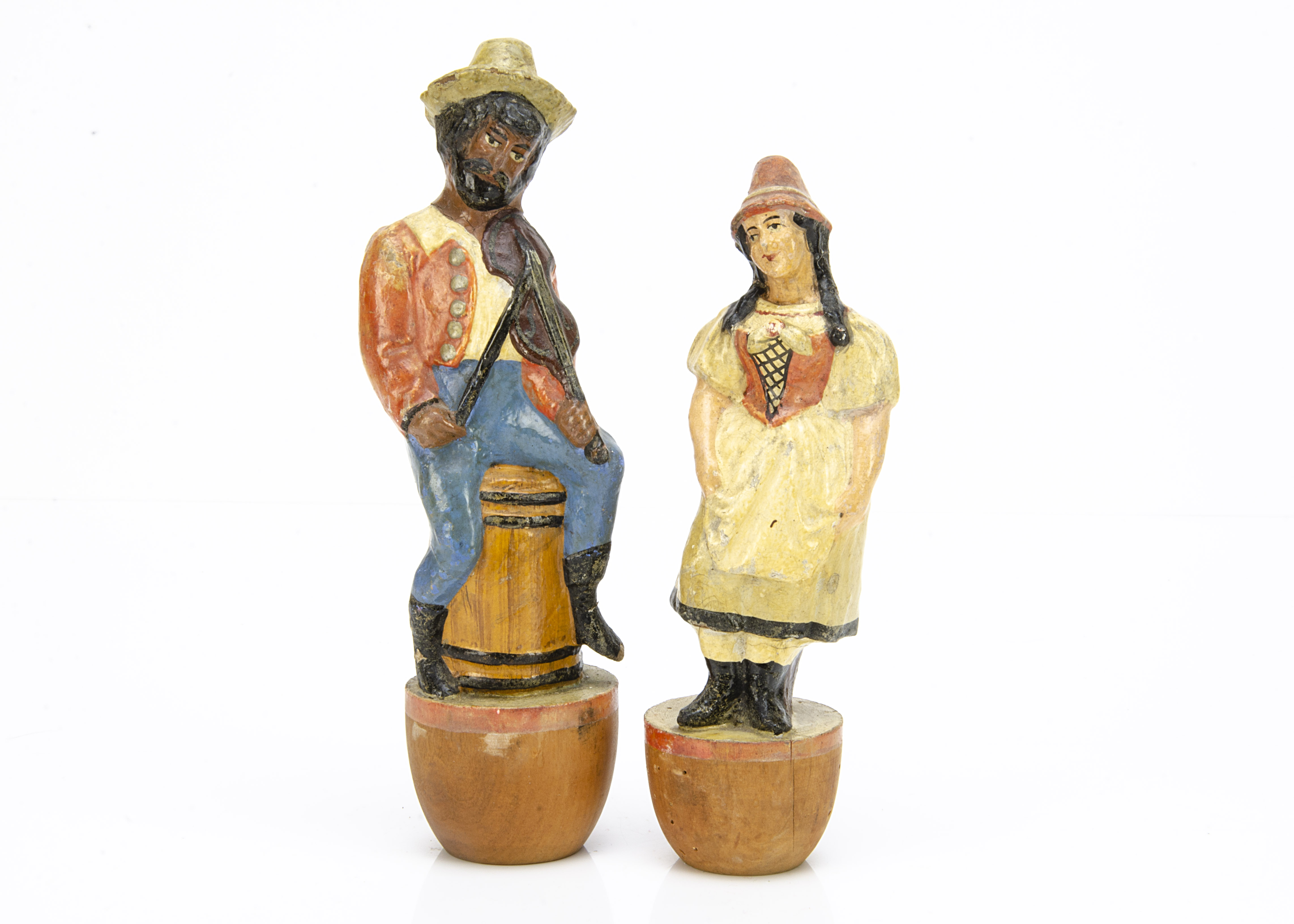 Two papier-mâché figural skittles circa 1900, one a black man seated on a barrel playing a violin