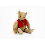 An early teddy bear circa 1910, German or American with golden mohair, black boot button eyes,