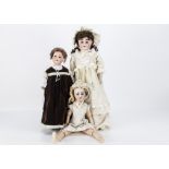 Three Armand Marseille child dolls, an Alma shoulder-head with kid Universal jointed body, bisque