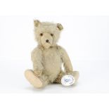 A German musical teddy bear from the Cotswold Teddy Bear Museum, with blonde mohair, orange and