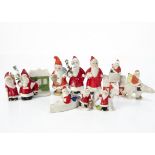 Eleven bisque Father Christmas cake decorations, including one riding a polar bear, looking in a