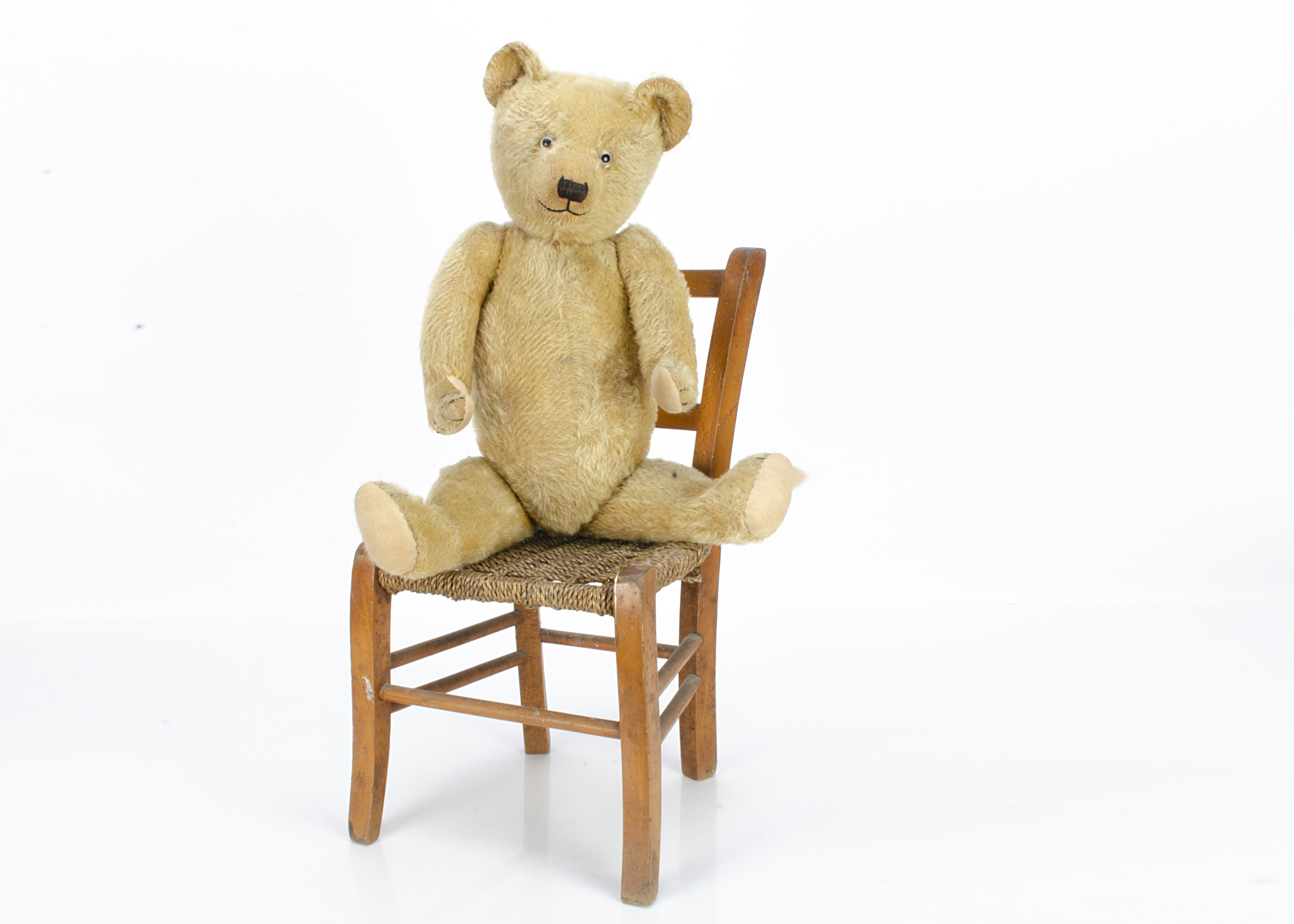 A Chiltern teddy bear late 1920s, with light golden mohair, clear and black glass eyes, pronounced