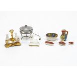 Dolls' house chattels, comprising a gilt metal cruet with two glass bottles --1 ¾in. (4.5cm.)