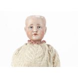 A Kämmer & Reinhardt 114 Gretchen child doll, with blue painted eyes, closed pouty mouth, jointed