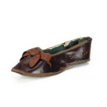 A 19th century leather slipper nécessaire, with dark green lining and sole and ribbon on front --