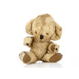 A small Merrythought Cheeky teddy bear circa 1960, with blonde artificial silk plush, orange and