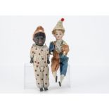 A German clown toy, with bisque head, wooden limbs, original clown costume, when pressed he