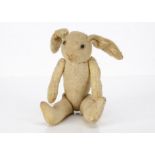 A soft toy rabbit to dress, probably French with cream wool plush head, ears and arms, clear and