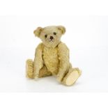 A fine Farnell teddy bear 1910s-20s, with blonde mohair, black boot button eyes, pronounced