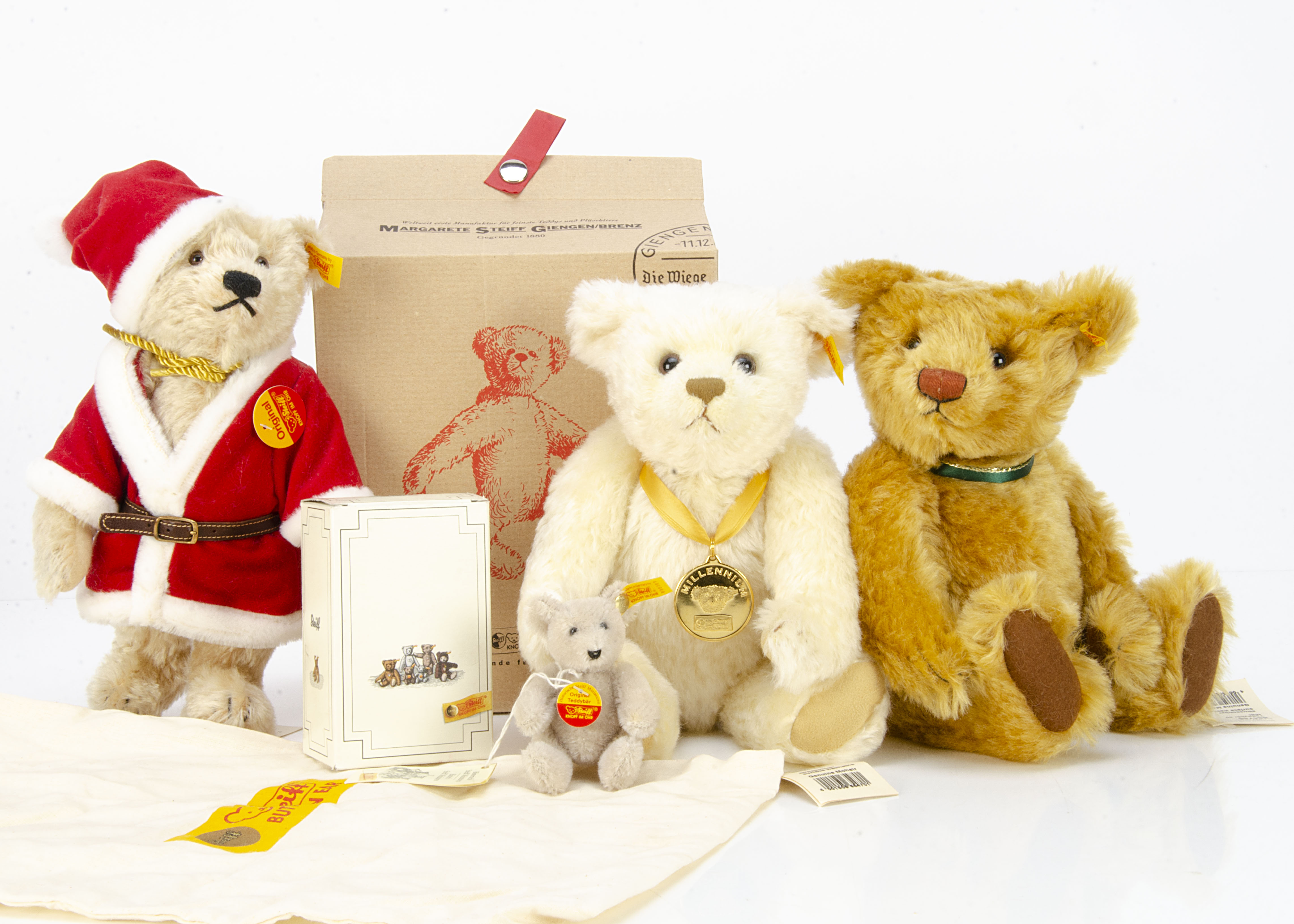 Four yellow tagged Steiff teddy bears, a Father Christmas teddy bear --10 ½in. (26.5cm.) high; two