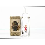 A Japanese clockwork Mechanical Acrobat, with celluloid boy on metal frame, in original box,