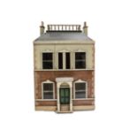 A painted wooden dolls' house, the painted stone and brick façade with central dummy front door with