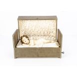 A early 20th century French wax Christ Child musical automaton, of poured wax sleeping Jesus with