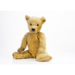 A 1930s Chiltern Hugmee teddy bear, with golden mohair, clear and black glass eyes with brown