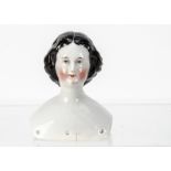 A china shoulder head doll, with blue painted eyes, rosy cheeks and chin, black painted and