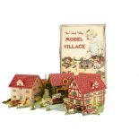 A Chad Valley cardboard Model Village, with seven folding printed buildings, a paper floor plan, a