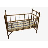 A small child's bamboo bed circa 1900, with brass fittings and original striped mattress --39 ½