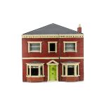 A late 19th century carpenter built dolls' house, with red brick exterior, white painted stone work,
