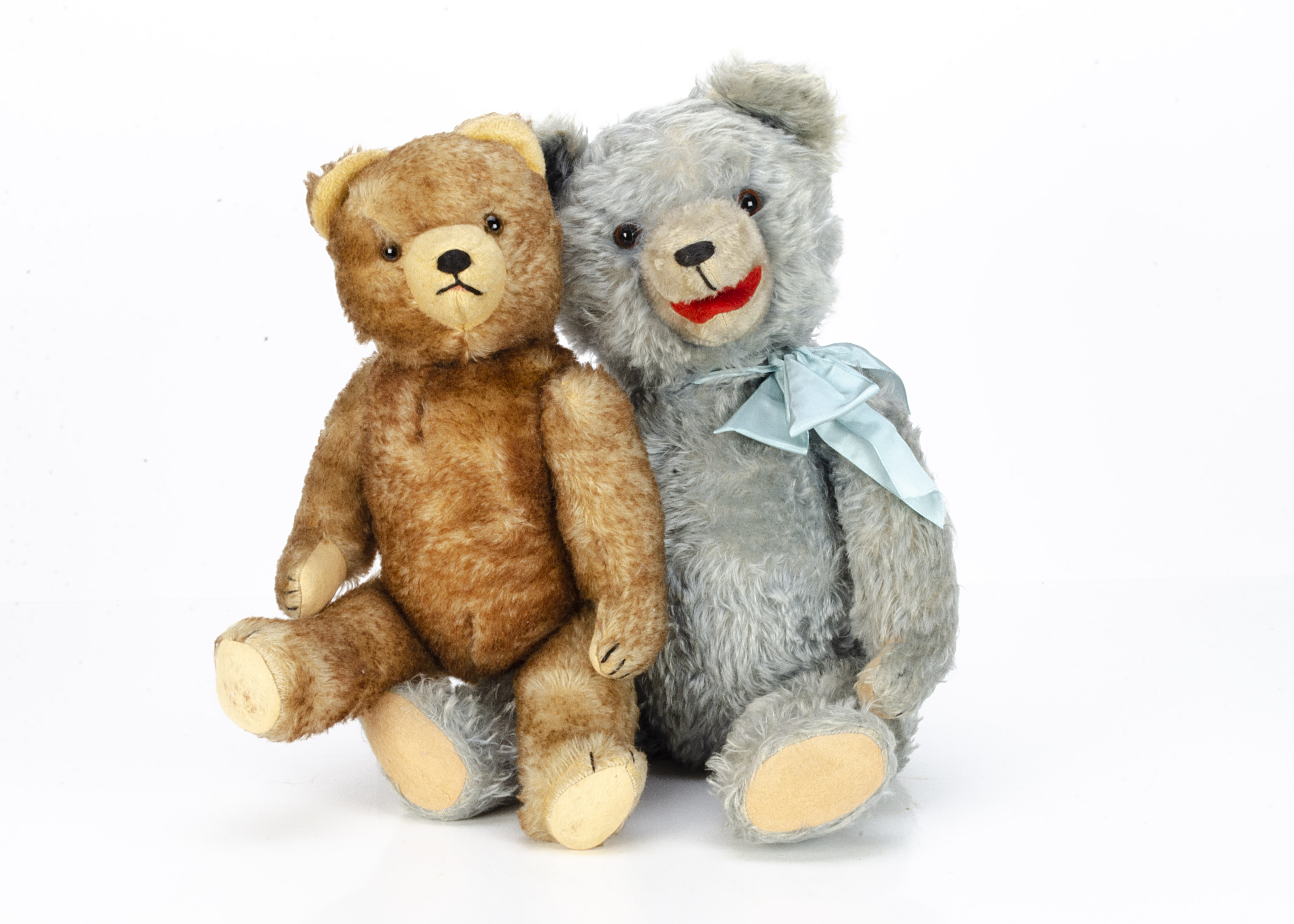 Two post-war Hermann-type teddy bears, a blue mohair example with orange and black glass eyes, inset