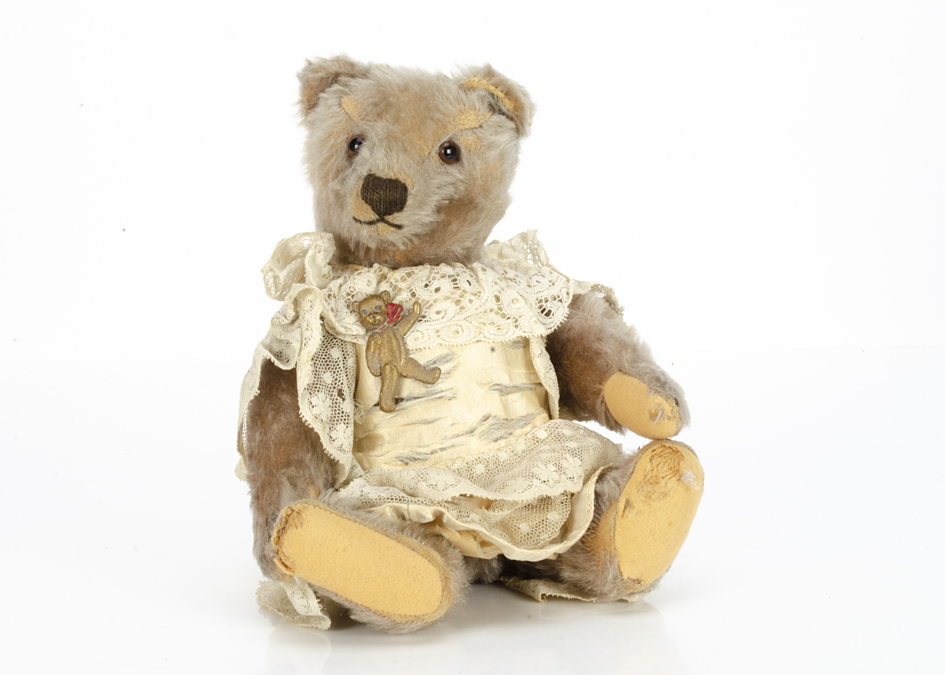 A 1950s Steiff teddy bear, with beige mohair, clear and black glass eyes with brown packs, muzzle