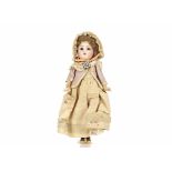 A small Kämmer & Reinhardt 192 child doll, with brown sleeping eyes, brown mohair wig, jointed