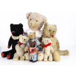 Seven European teddy bears, a Russian clockwork bear with brown artsilk plush and original Cossack