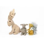 Three artist made animals, a grey artificial silk plush seated donkey with swivel head --5½in. (