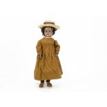 A German black bisque headed child doll marked C, with brown sleeping eyes, pierced ears, black